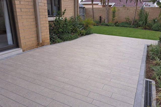 Long large-format pavers in Stone grey